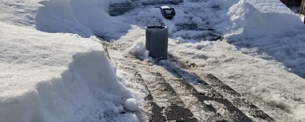 snow removal on asphalt shingle roof